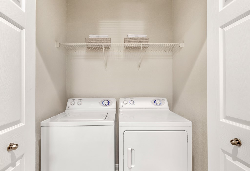 A small laundry room with a washer and dryer.