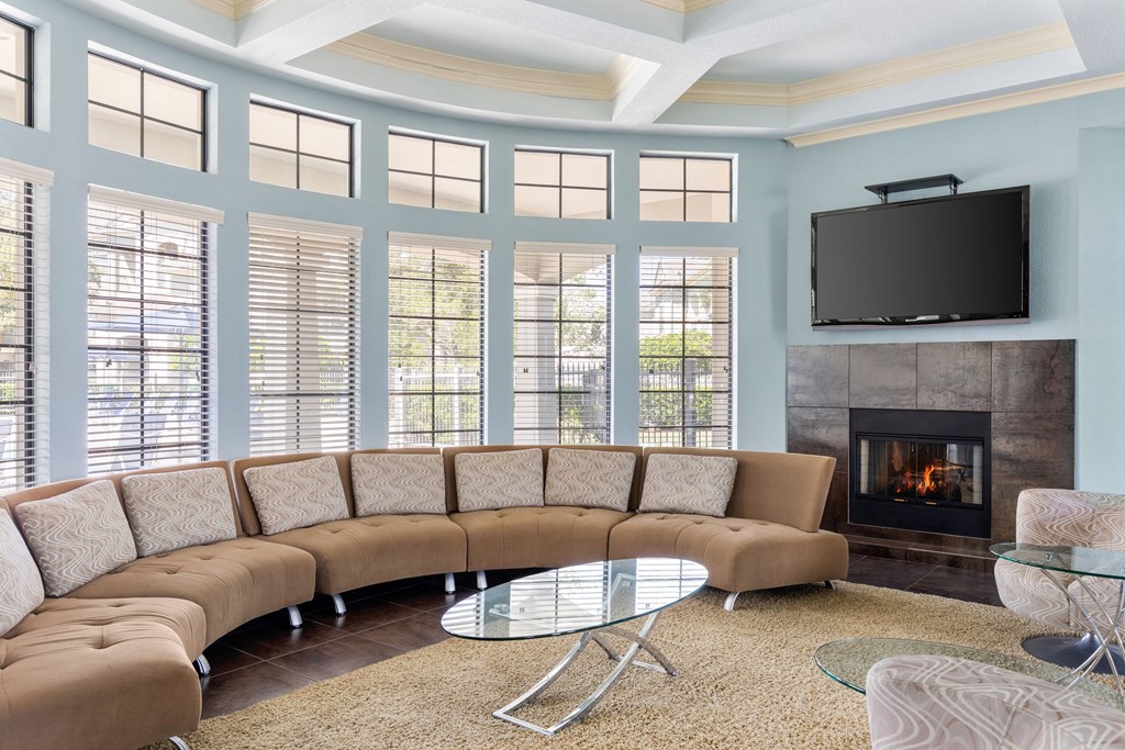 A living room with a fireplace and a television.
