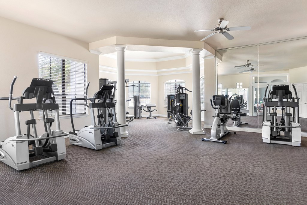 A spacious gym with a variety of exercise equipment.