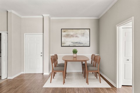 A dining room with a table and chairs.