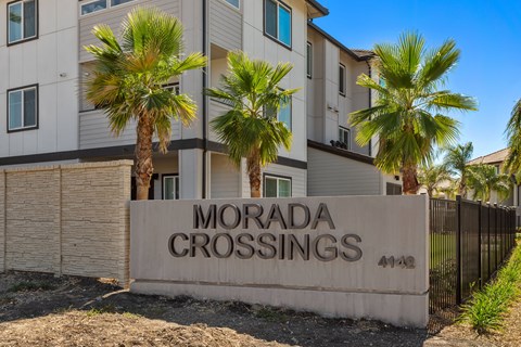 A building with a sign that says Morada Crossings in front of it.