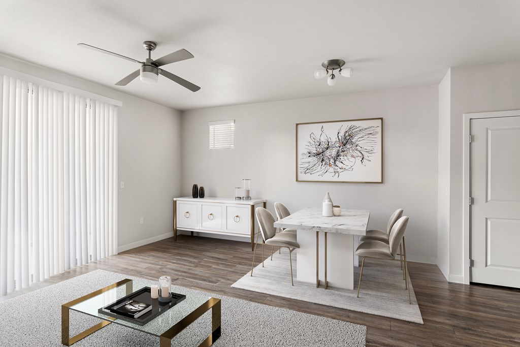A modern dining room with a glass coffee table and white chairs.