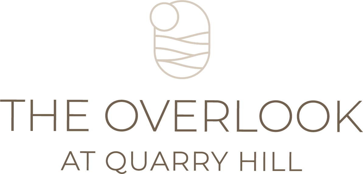 A logo with a baby in a cradle and the words "The Overlook at Quarry Hill".