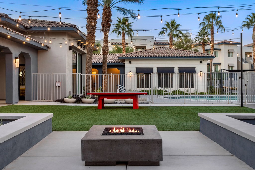 A modern house with a red bench in front of it.