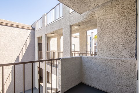 A white building with a balcony and a staircase.