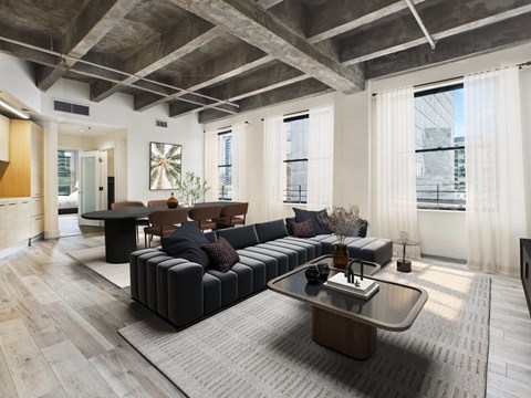 A modern living room with a black sofa and a wooden coffee table.