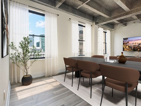 A dining room with a brown table and chairs.