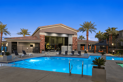 A large house with a pool in front.