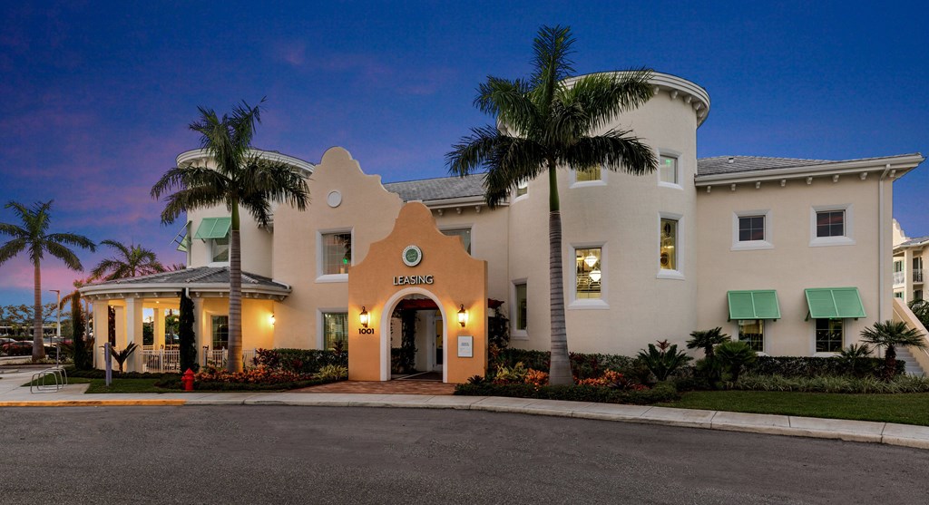 A building with a palm tree in front of it.