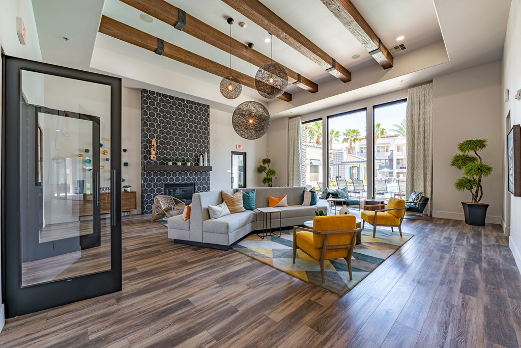 A modern living room with a white sofa and yellow chairs.