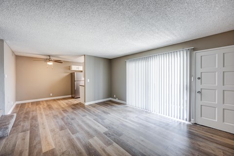 A room with wooden flooring and a white door.