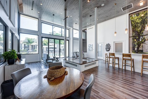 A modern dining room with a wooden table and chairs.