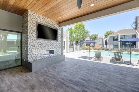 A modern house with a wooden ceiling and a television mounted on the wall.