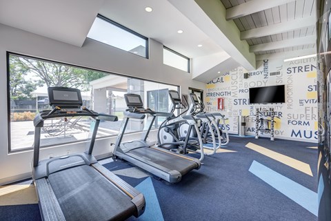 A gym with treadmills and exercise bikes.