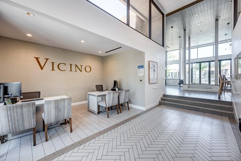 Vicino's interior lobby area with a reception desk and chairs.