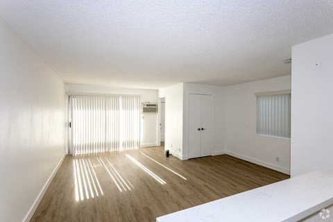 A room with wooden floors and white walls.