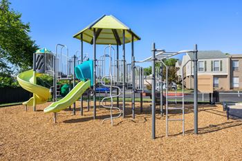 A playground with a yellow slide and a yellow canopy.
