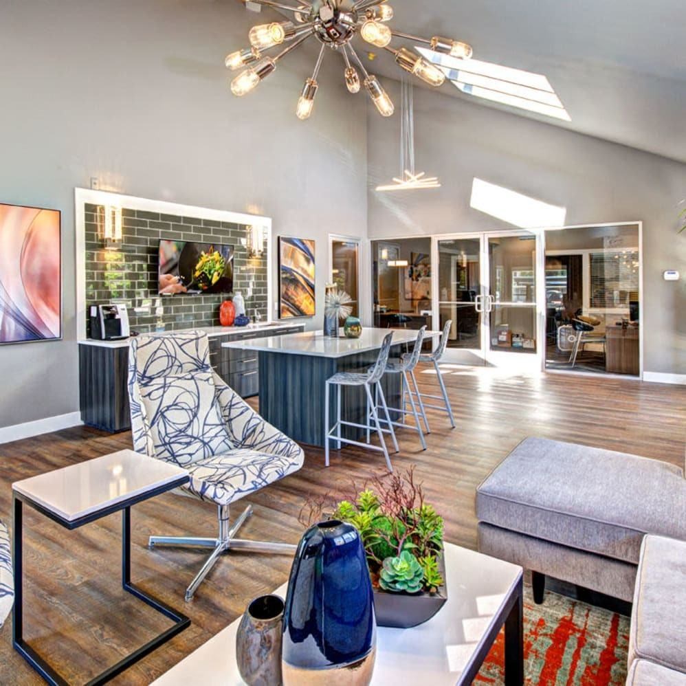 A modern living room with a wooden floor and a grey sofa.