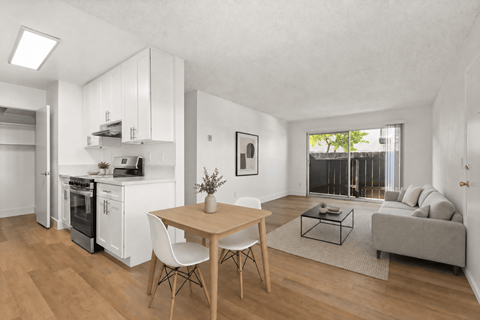 A modern kitchen with a dining table and chairs.
