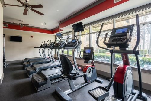 A gym with treadmills and elliptical machines.