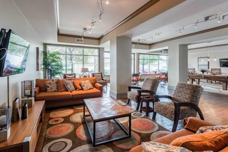 A living room with a brown couch and a coffee table.