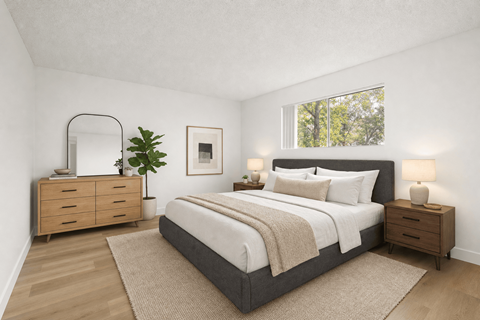 A bedroom with a large bed, a dresser, and a mirror.