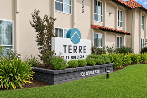 A sign for Terre at Mollison in front of a building.