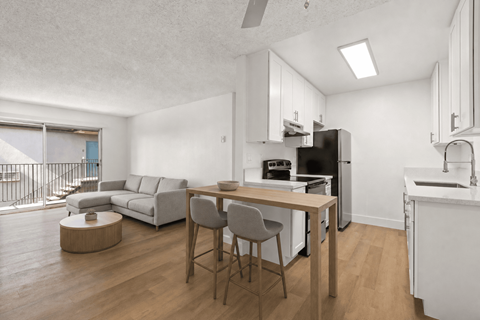 A modern kitchen with a dining table and chairs.