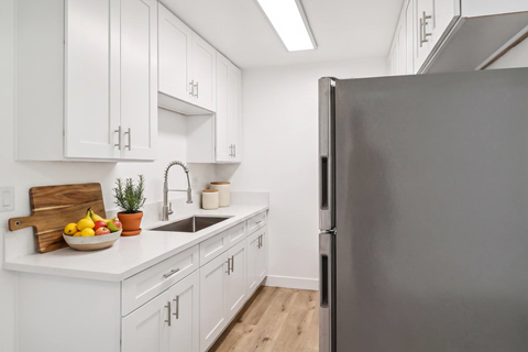 A modern kitchen with a refrigerator on the right.