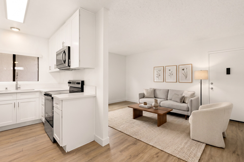 A modern living room with a grey couch and a wooden coffee table.