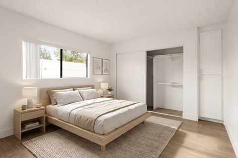 A bedroom with a large bed and a window.
