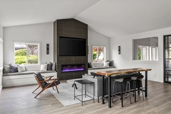 A modern living room with a fireplace and a television.