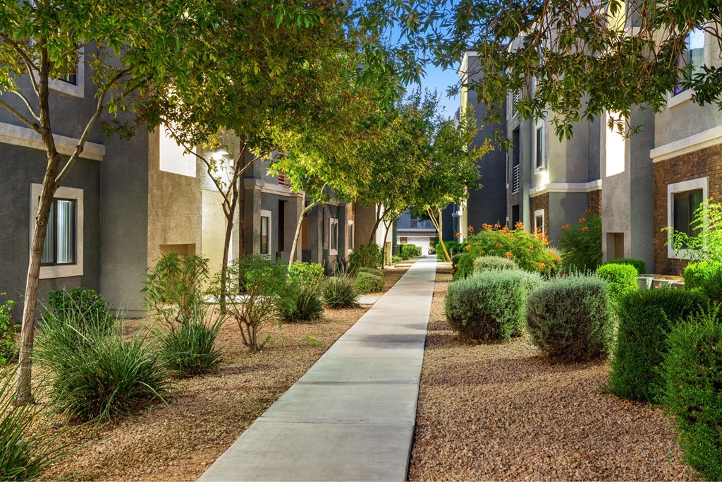 A long concrete walkway leads between two rows of houses.
