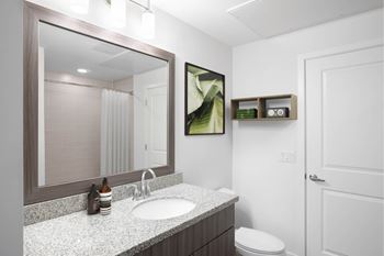 A bathroom with a white toilet and a sink.