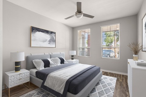 A bedroom with a large bed and a ceiling fan.