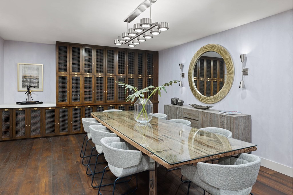 A dining room with a wooden table and grey chairs.
