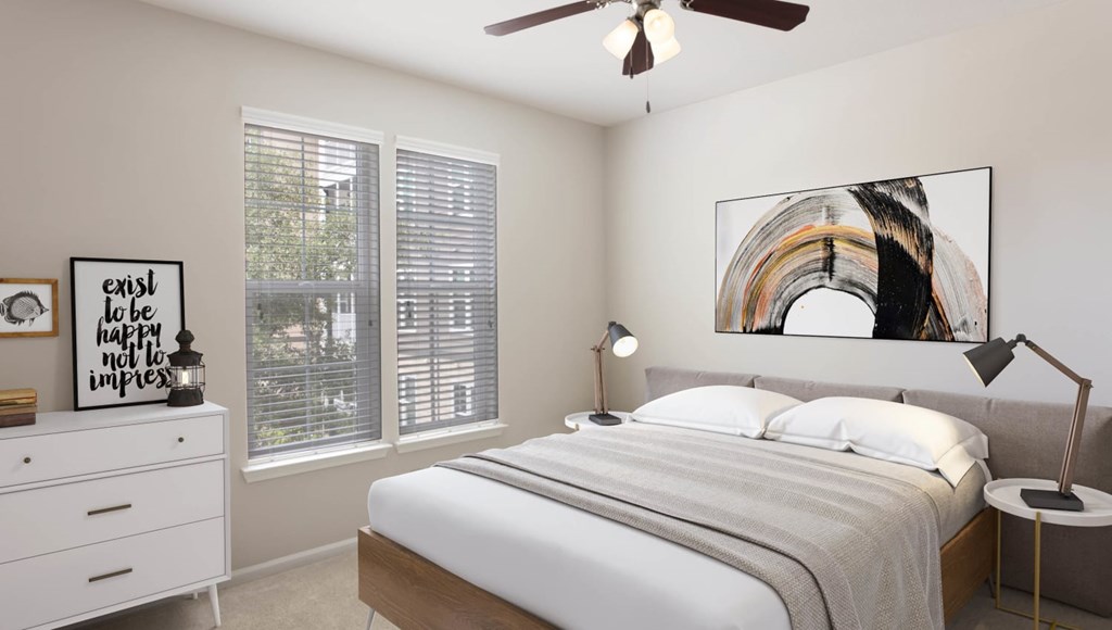 A bedroom with a bed, nightstand, and a painting on the wall.