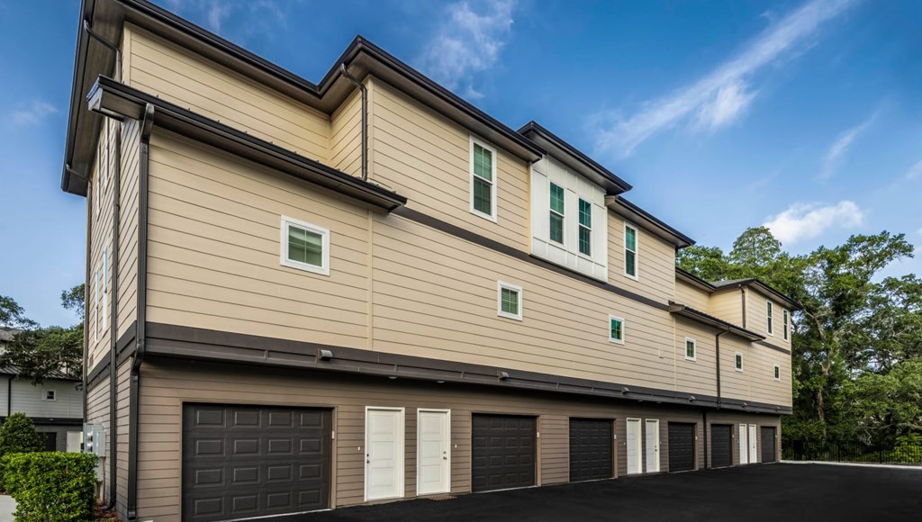 A modern two-story house with a garage on the ground floor.