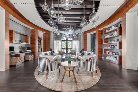 A modern living room with a checkered chair set and a round table.