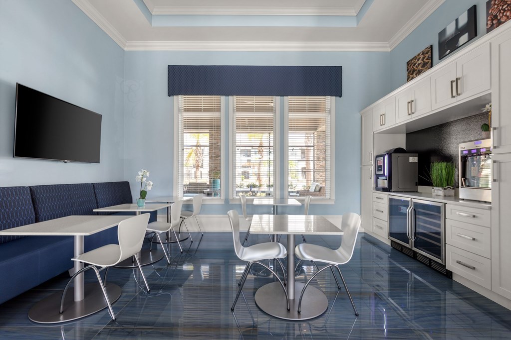 A modern kitchen with a dining table and chairs.