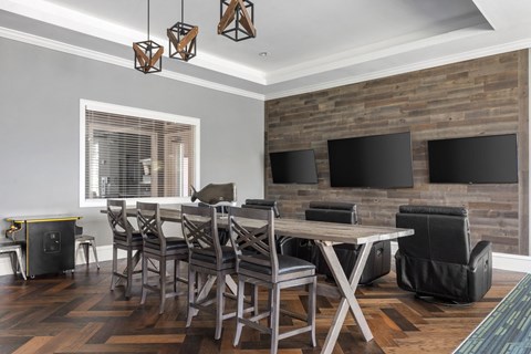 A modern dining room with a wooden table and chairs.