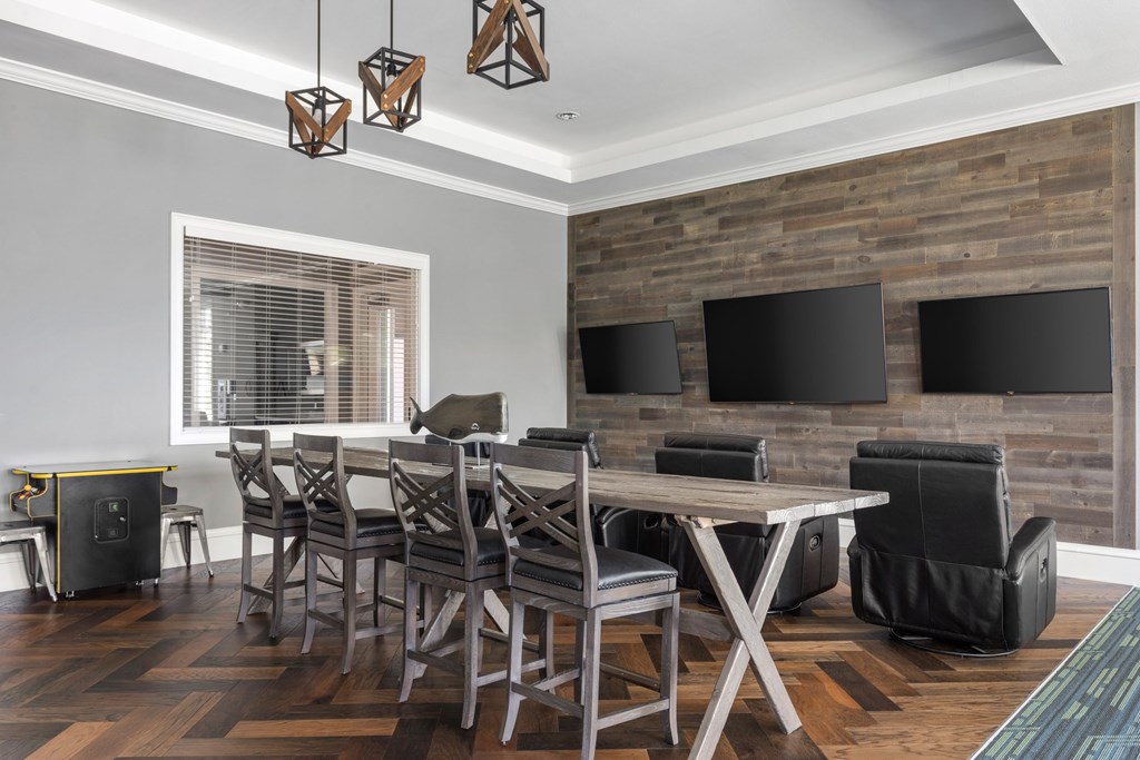A modern dining room with a wooden table and chairs.