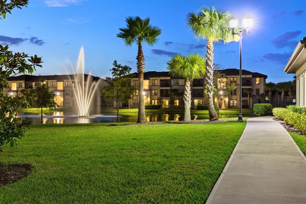 A building with a fountain in front of it.