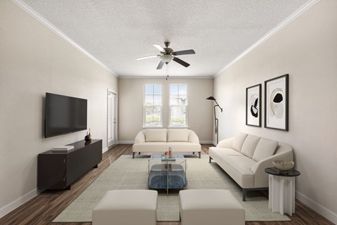 A living room with a white couch, a coffee table, and a flat screen TV.