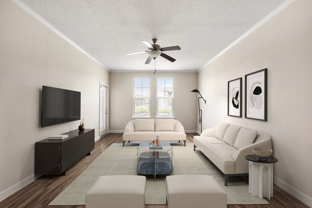 A living room with a white couch, a coffee table, and a flat screen TV.