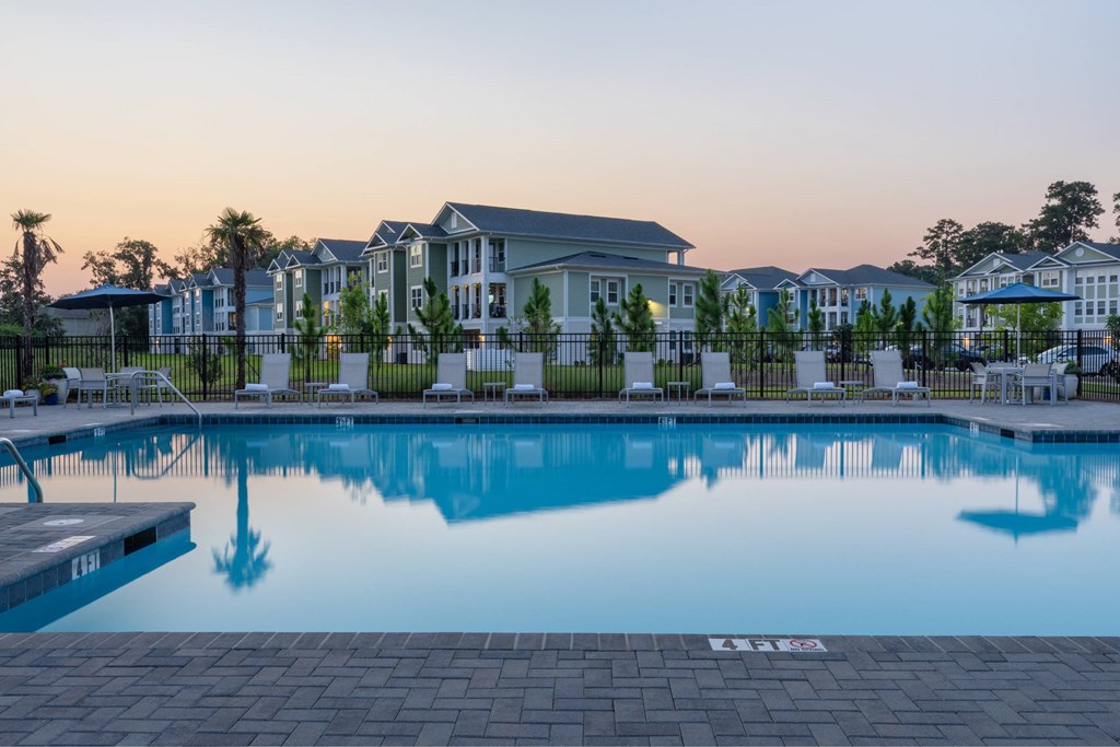 A swimming pool in front of a building with a number 133 on the ground.