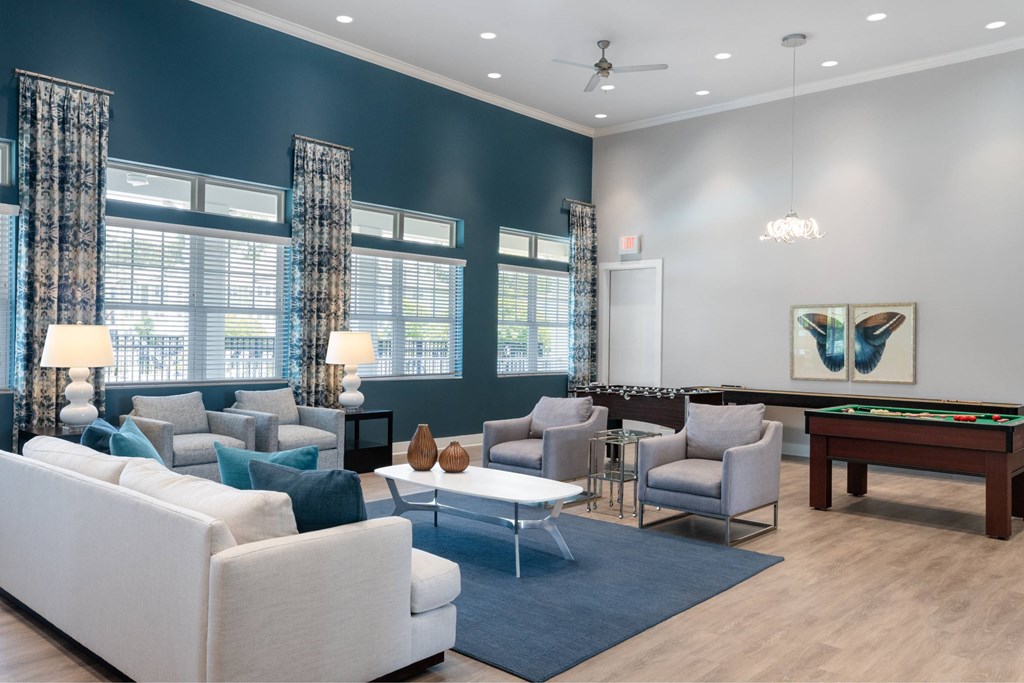 A spacious living room with a pool table and comfortable seating.