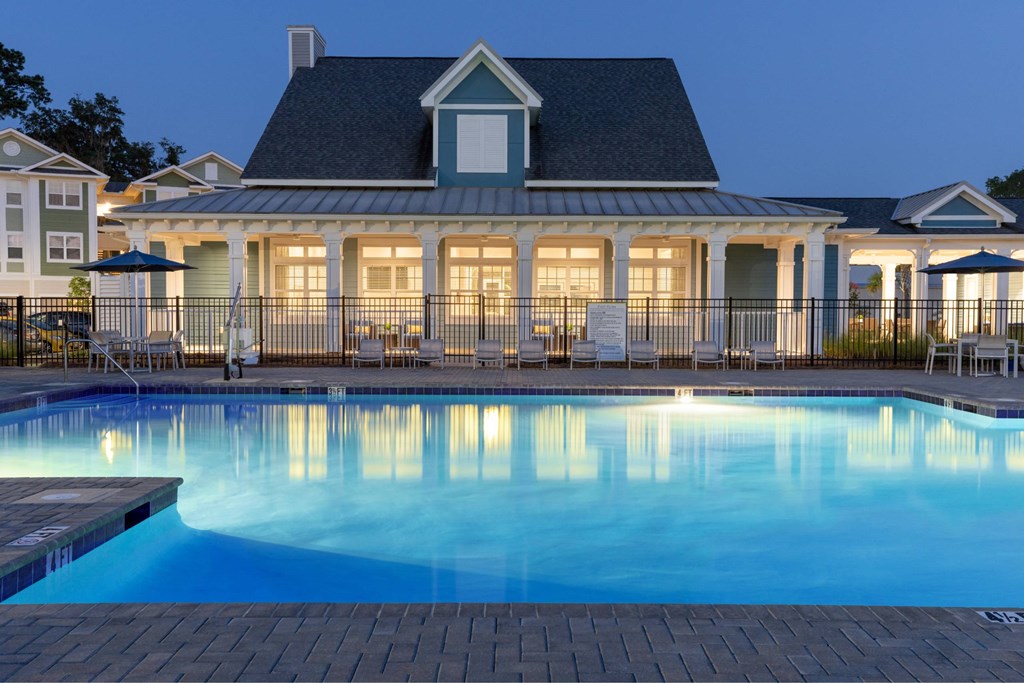 A large house with a pool in front.