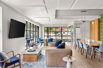 A modern living room with a flat screen TV mounted on the wall.
