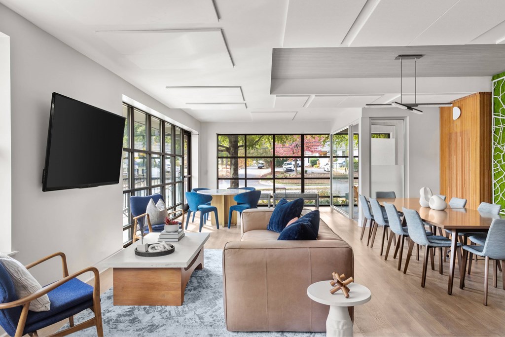A modern living room with a flat screen TV mounted on the wall.